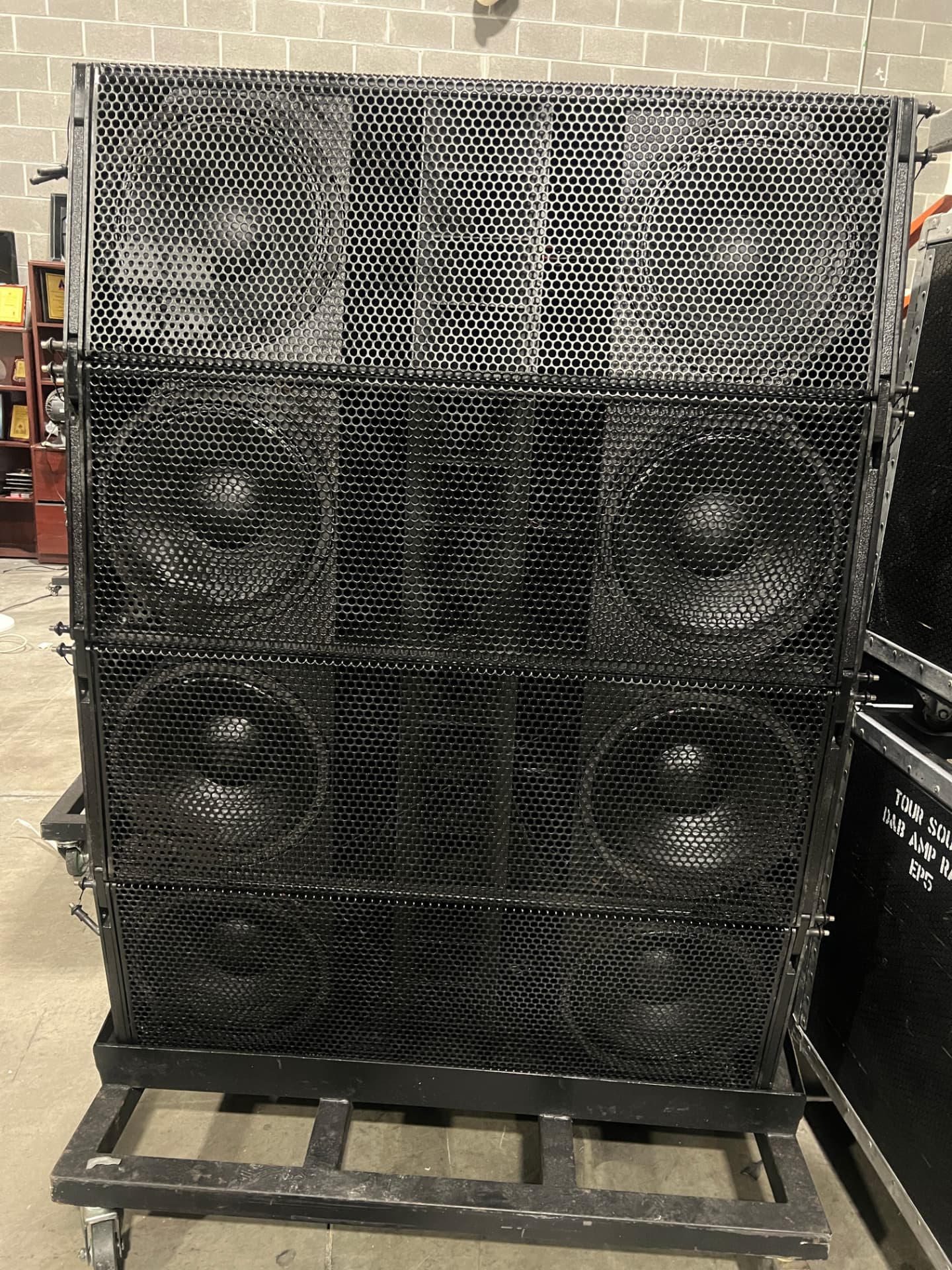 Ground-stacked line array cabinets on a rolling dolly