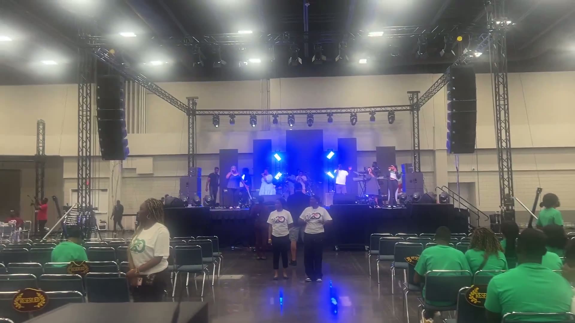 Live band on a stage during soundcheck inside a large hall