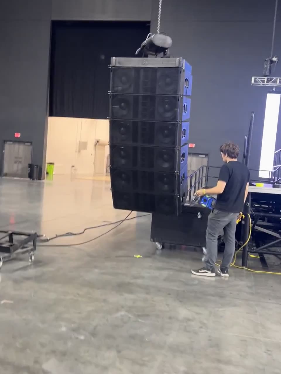 Front view of an arena stage with line array and lighting truss