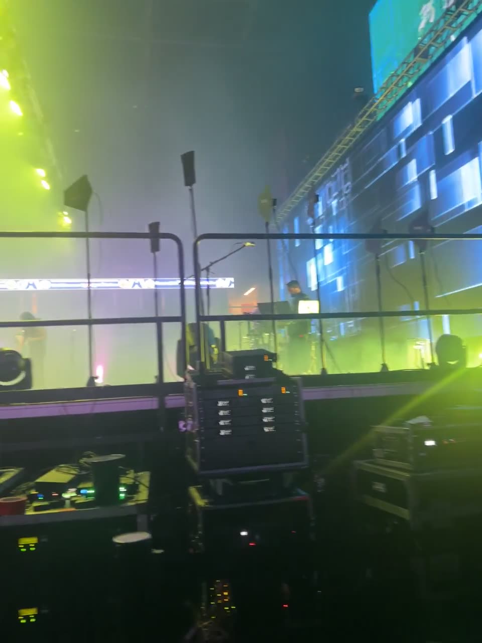 Rack of wireless microphone receivers and comms gear at an arena show